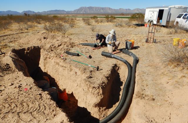 trenches with black drain pipe