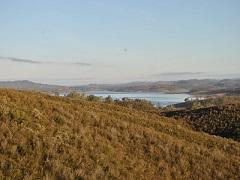 Photo of a lake nestled between foothills.