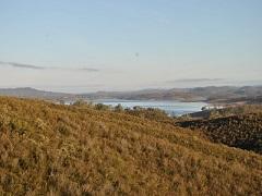 Photo of a lake nestled between foothills.