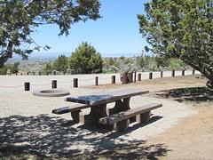 Picnic table in shade overlooking high desert landscape. Photo by the BLM.