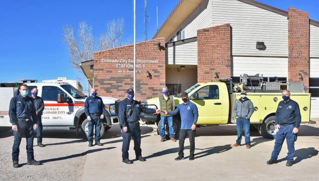 Members of the Hildale-Colorado City Fire Department and BLM's Arizona Strip District standing in front of fire engines and the fire department. 