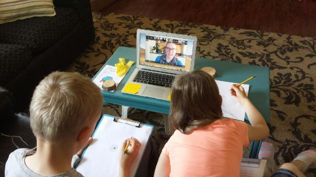 two children with computer doing distance learning from the Campbell Creek Science Center