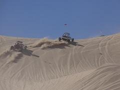 Two buggies race up a dune. Photo by Jim Pickering, BLM.