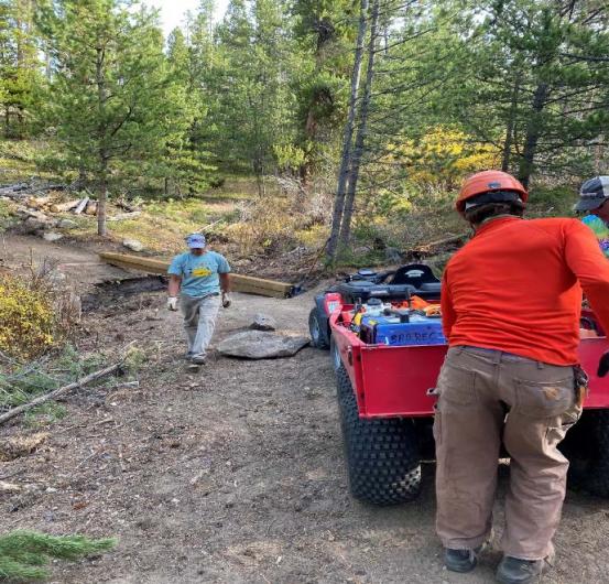 two people work on a trail 