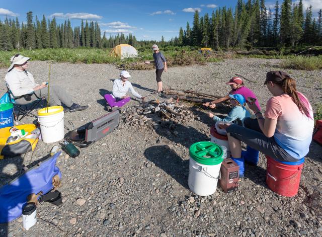 A group camps on a sandbar