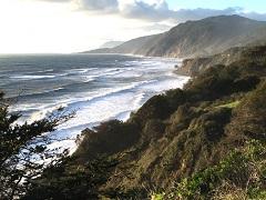 Clouds float over a rocky and rugged coastline