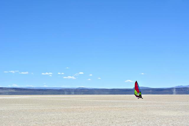 Kite boarder moves across the open landscape