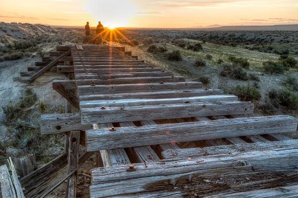 BLMers Mike Nelson and Cassie Mellon look at a trestle along the Transcontinental Railroad Grade. 