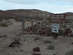 Image of a gate and sign in the Mojave desert.