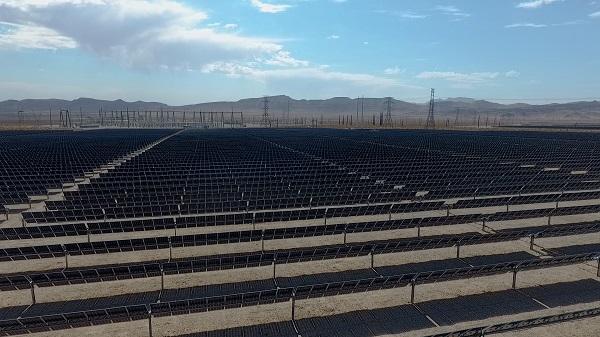 Ground view of MGM Mega Solar Array with transmission lines in the background. 