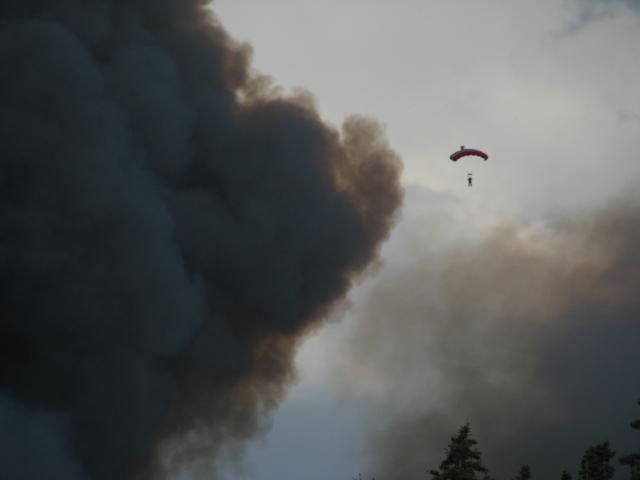 Smokejumper falling past smoke column