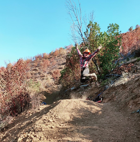 person jumping for joy in an outdoor landscape with the caption, A BLM employee checks for ideal flow. Come check out the Mountain of the Rogue, we have it dialed back in