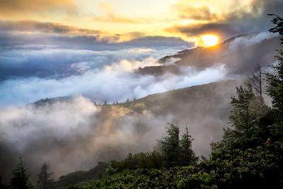 Sun sets over clouds and mountains. Photo by Bob Wick, BLM.