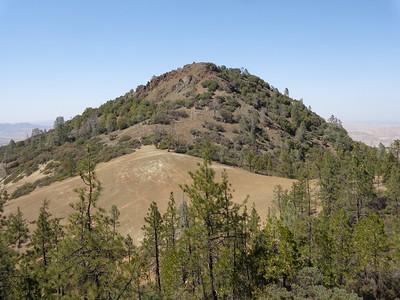 A foot hill peak with scattered trees.