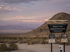 BLM CA CDD Sign with desert an mountains in the background.