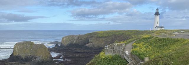 photo of a lighthouse on a cliff above the ocean