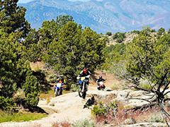 People riding off road motorcycles.