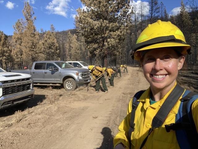 Woman in firefighting gear smiling