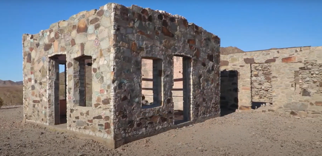 old cabin built with large blocks of granite of various colors