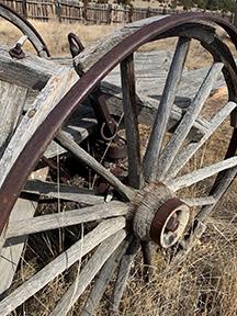  Forged iron wagon wheel assembly, complete with metal bands on the wheel and spoke