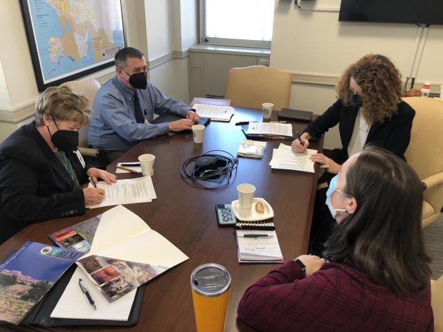 BLM Director and members of Public Lands Foundation sit around table to sign new partnership agreement