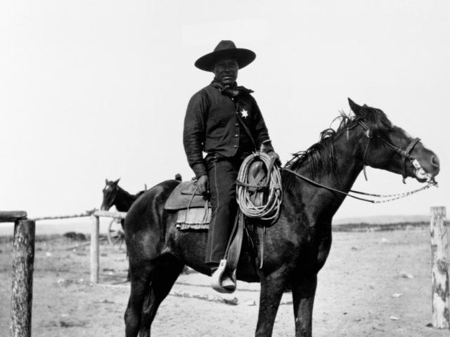 Historical photo of black cowboy on horseback