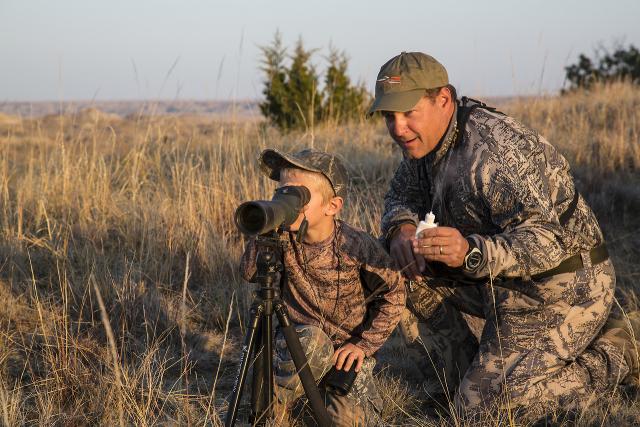 Hunting Fishing and Recreational - FatherAndSonUsingASpottingScope 