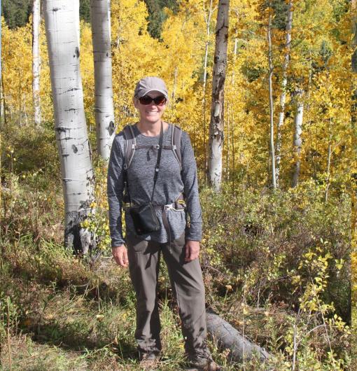 Woman standing in the woods.