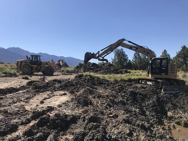 A machine shoveling dirt