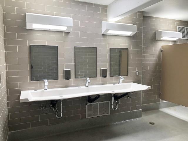 Renovated restroom at Virgin River Campground - 3 mirrors over a bank of 3 sink/faucets. 