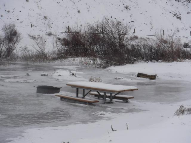 Ice and water near a picnic table