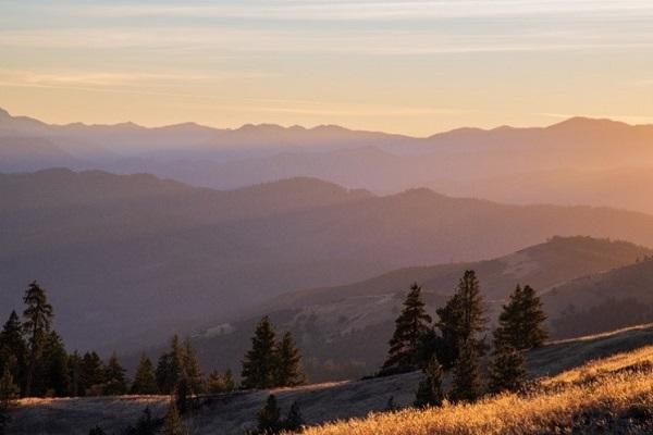 a sunset photo of mountains and open meadows from the Anderson Butte area outside of Medford, Oregon