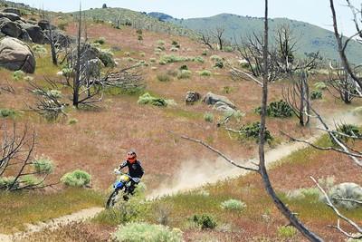 A dirtbike rider on a trail.