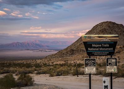 A desert sunset over a mountain.