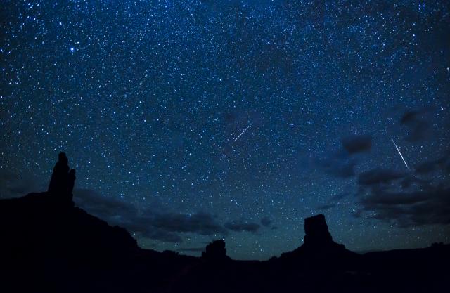 Perseid Meteor Shower over pointy, tall rock spires