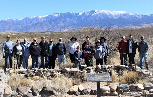 The group stands in front of the excavated prehistoric villages.
