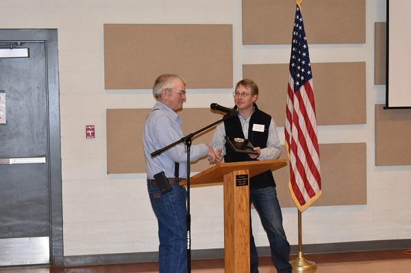 Lonnie Huter (right) receives his Weed Warrior honor by the Washington County Weed Advisory Board during their annual meeting.