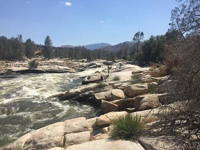Photo of water rushing along boulders on the Kern River. 