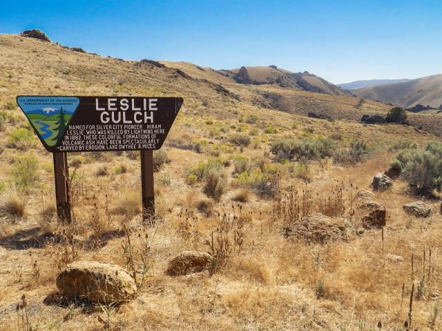 A sign for visitors summarizes the story of Leslie Gulch.