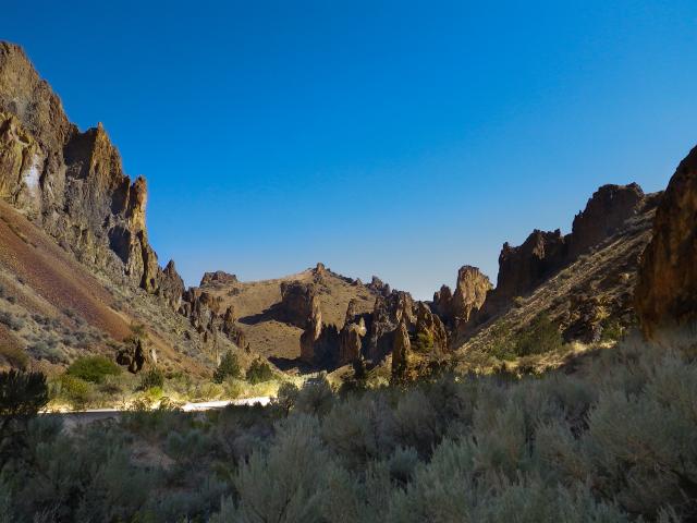 Craggy stone on both sides of a dirt road in Leslie Gulch.