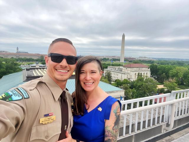 Ranger Marsh and fiancée Wendy Palmer on top of the Department of the Interior Building with the Washington Monument in the background. 