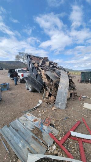 A dump trailer distributes materials to a recycling facility.