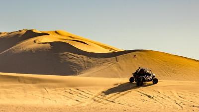 An off road vehicle on sand dunes