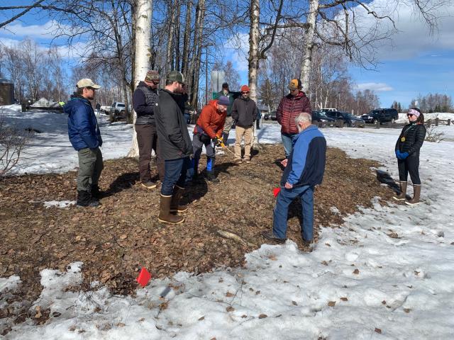 Outdoor scene, winter snow melts to reveal falls forgotten vegetation as recreation professionals learn how to build sustainable trails and account for slope and erosion while building a curved trail.