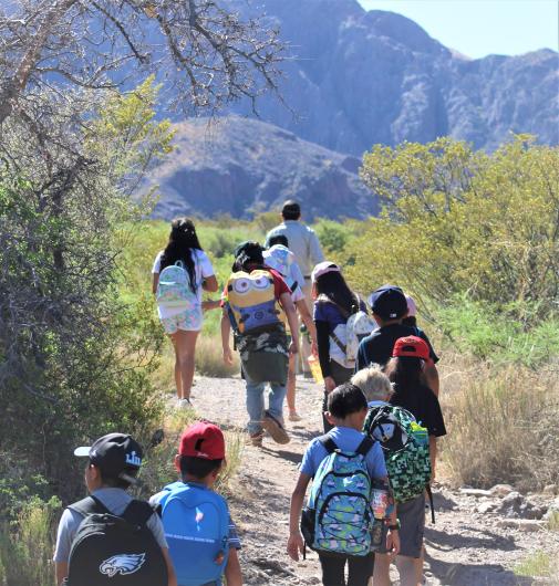 BLM Park Ranger Supervisor Patrick Driscoll takes Sunrise Elementary students on an interpretative hike to the La Cueva rock cave archeological site.