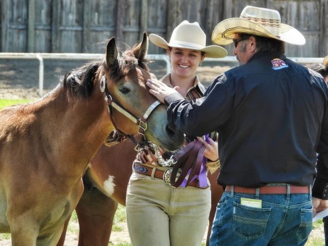 Man and woman with horse. 