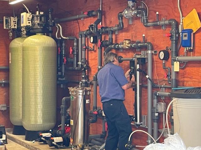 a technician works on the new water distribution and treatment system