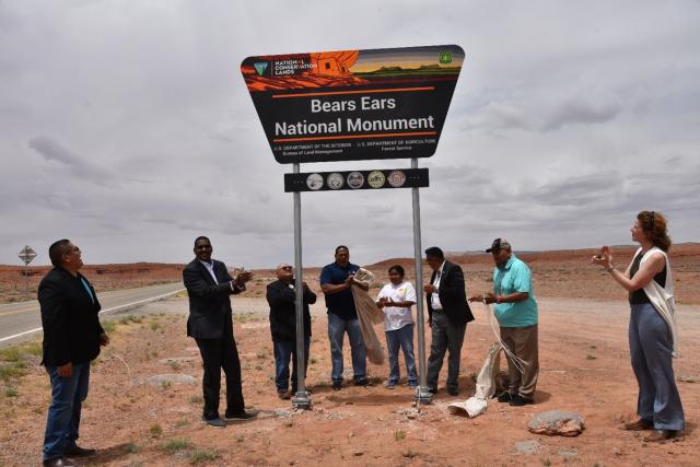 Dr. Homer Wilkes, Tracy Stone-Manning, and Tribal leaders clap after unveiling the new Bears Ears National Monument signage.