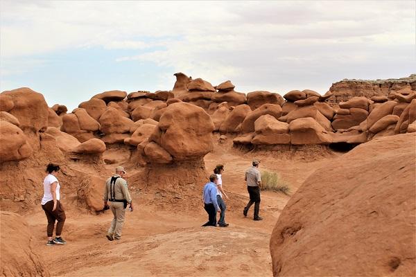 Visitors to Goblin Valley walking through the hoodoos.