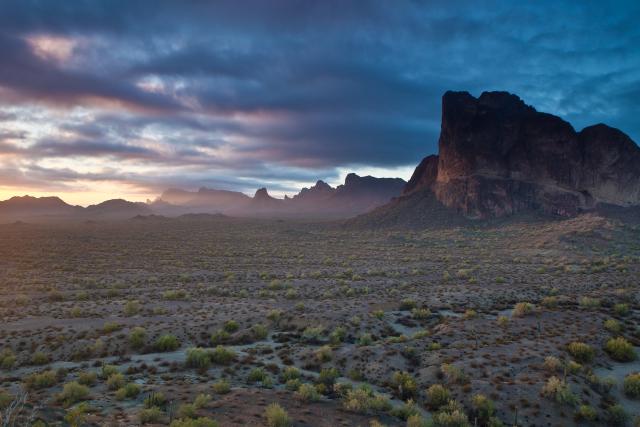 The Eagletail Mountains Wilderness in Arizona, with a cloudy horizon in the background and mountains in the foreground.